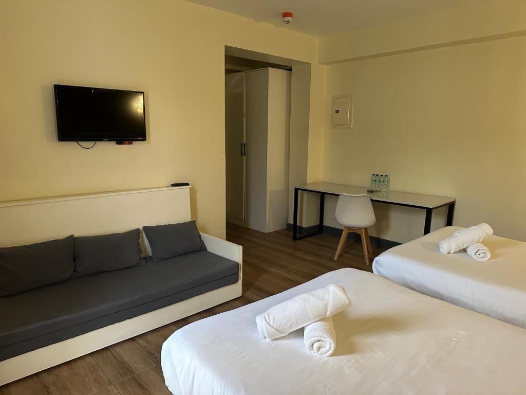 Postel nebo postele na pokoji v ubytování D'ELEMENTS HOTEL AND DORMITORY