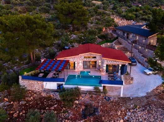 an overhead view of a house with a swimming pool at Villa NazlıSu in Kaş