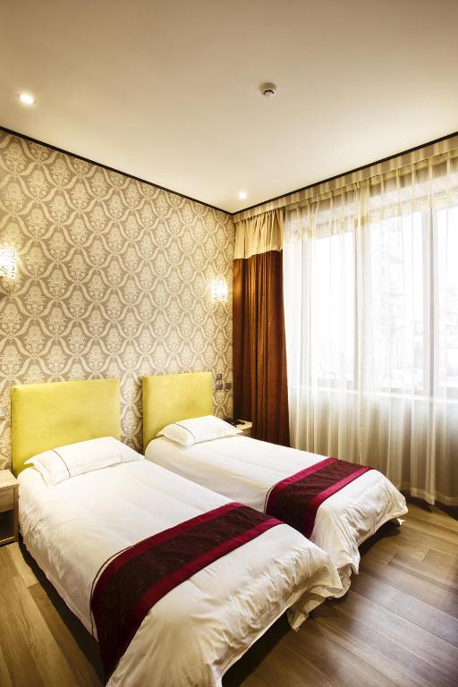 Postel nebo postele na pokoji v ubytování Igiban Hotel