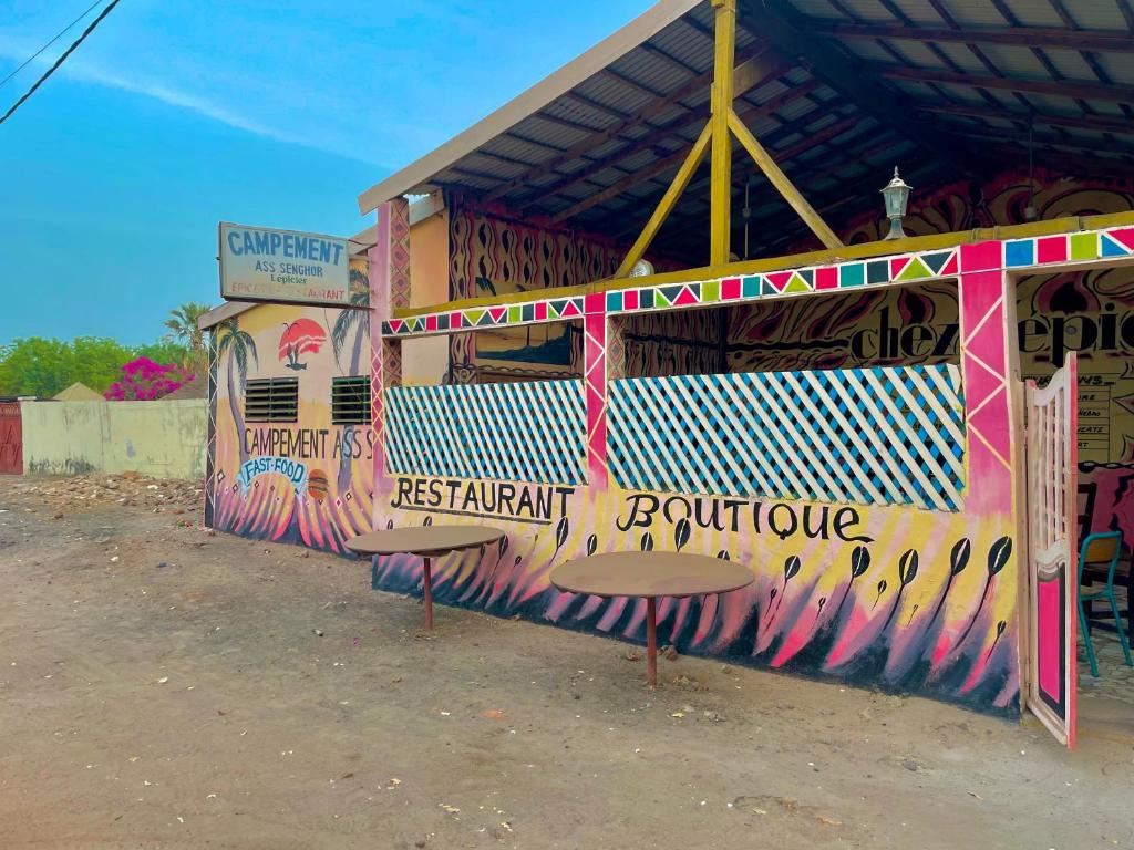 a building with graffiti on the side of it at Campement Ass Senghor in Toubakouta