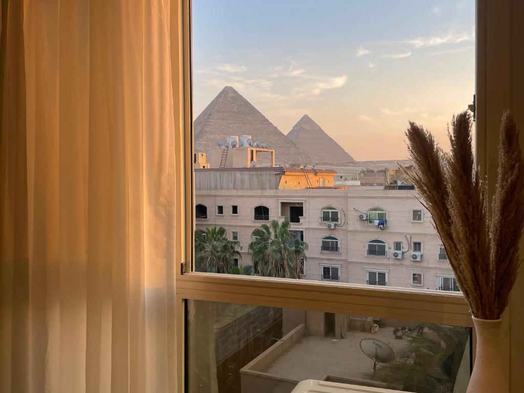 a view of the pyramids from a window in a hotel at Diyar Pyramids Inn in Cairo