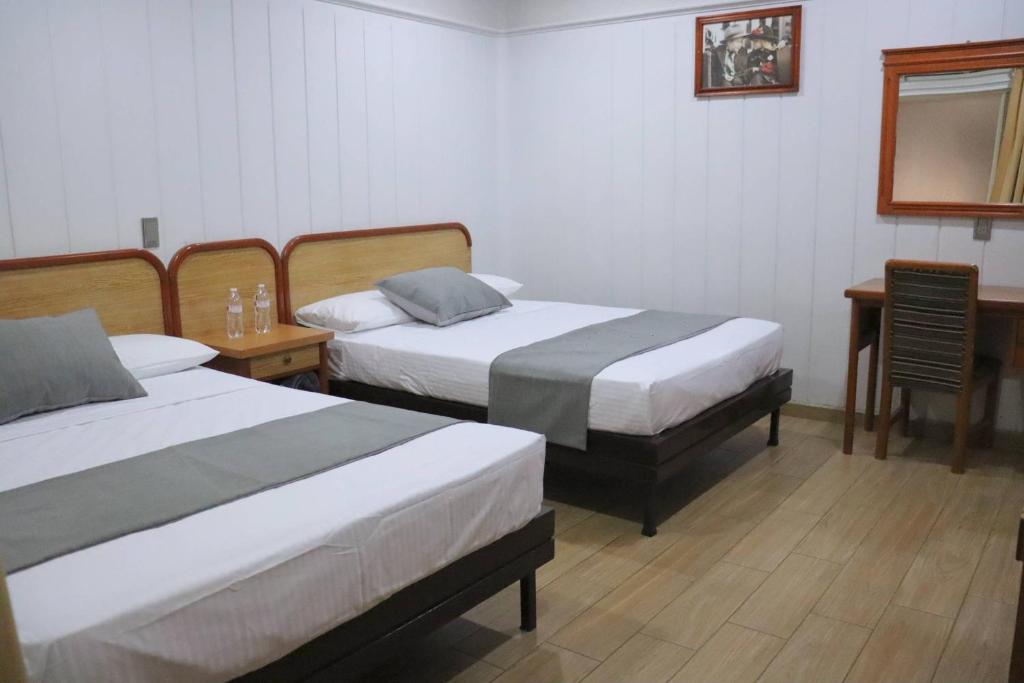 Postel nebo postele na pokoji v ubytování Hotel Riviera