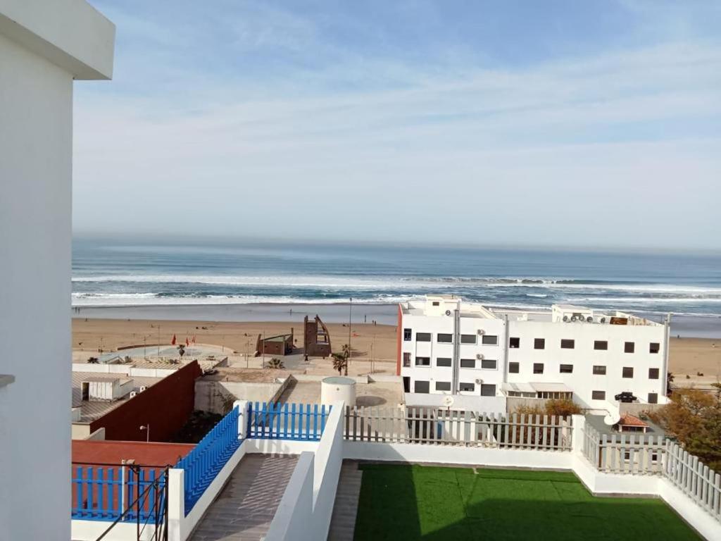 a view of the beach from the balcony of a building at Mehdia beach one in Kenitra