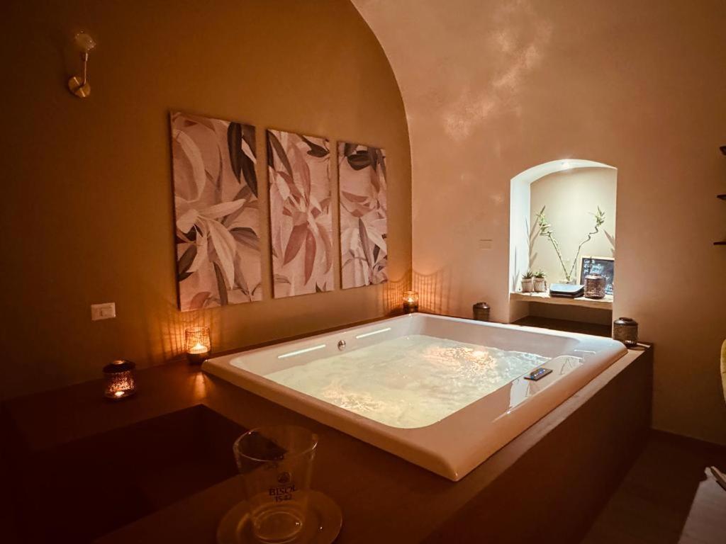 a large bath tub in a room with a mirror at Muralta Suite & Luxury Rooms in Altamura