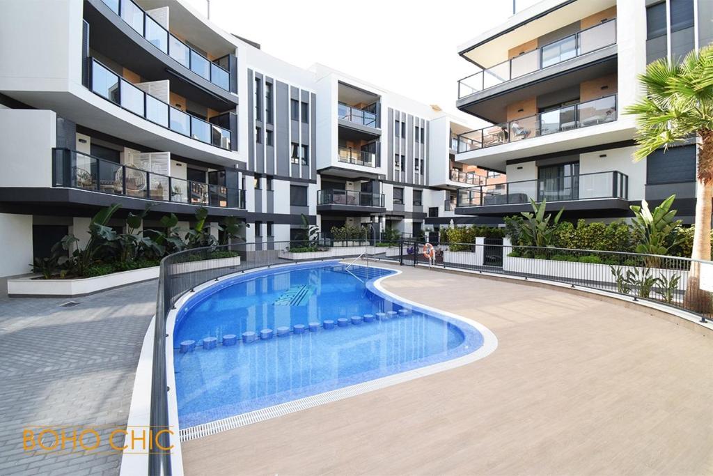 a swimming pool in front of a apartment building at Boho chic in Jávea
