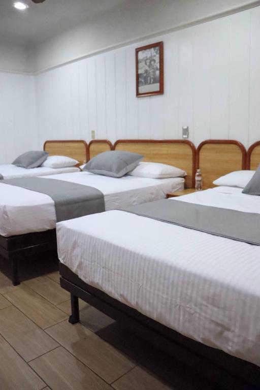 Postel nebo postele na pokoji v ubytování Hotel Riviera