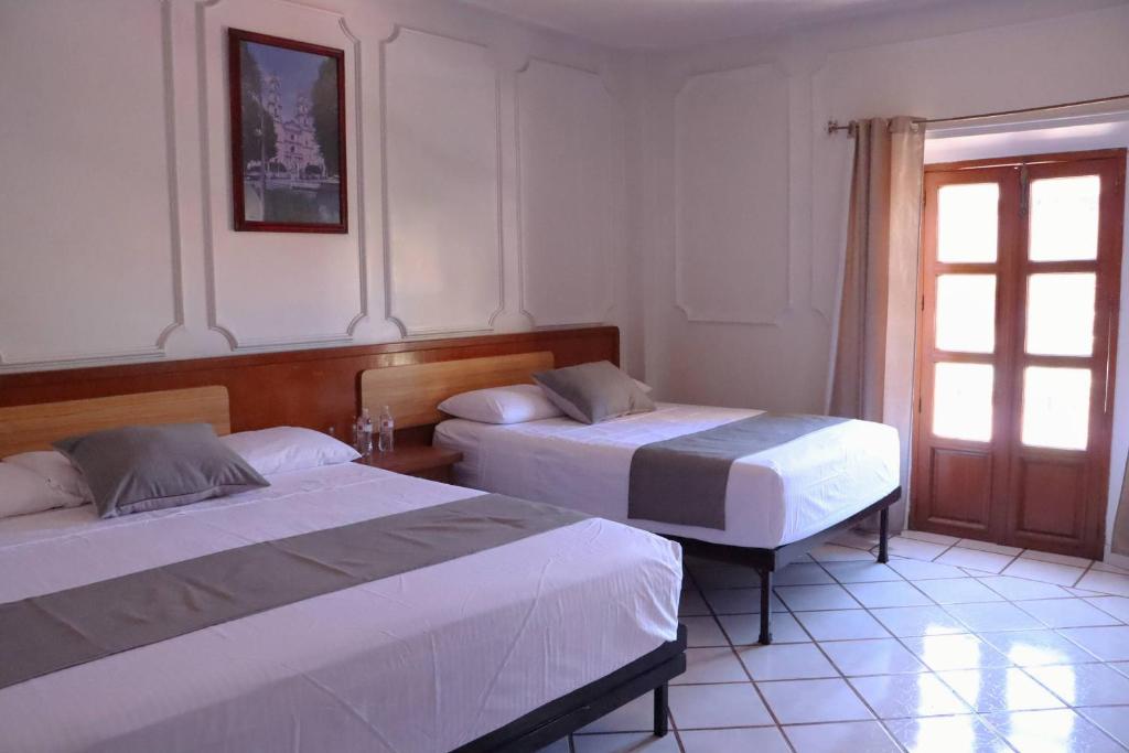 Postel nebo postele na pokoji v ubytování Hotel Riviera