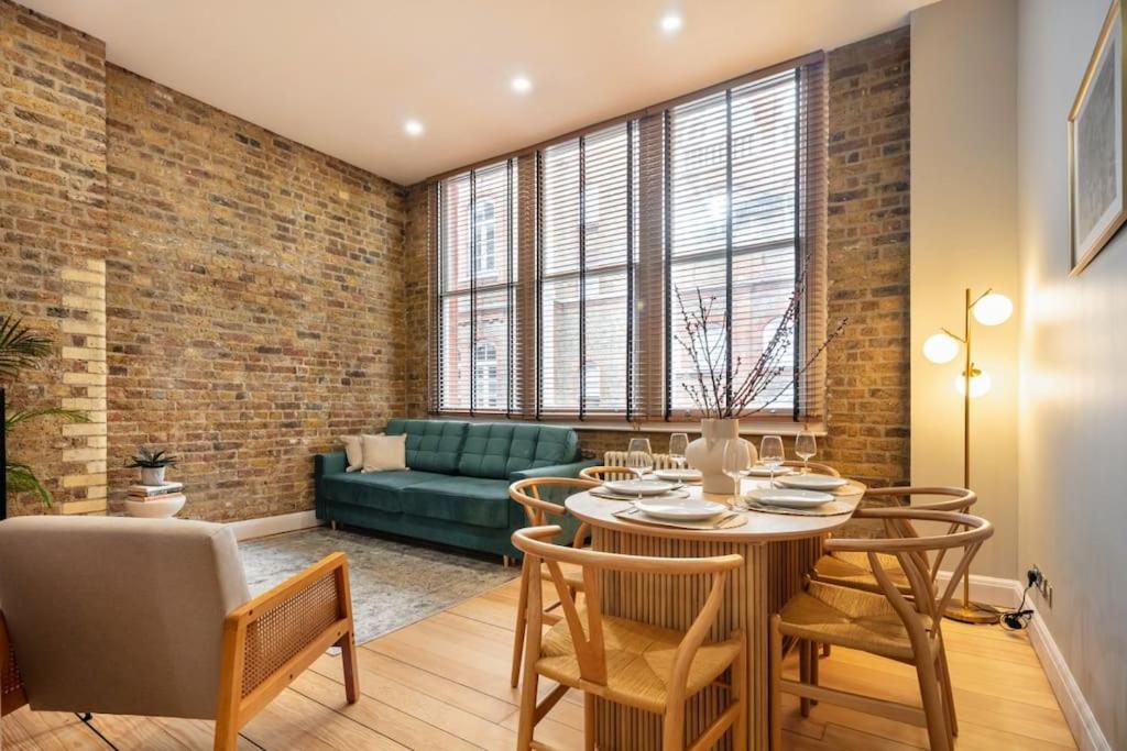 a living room with a table and chairs and a couch at Prime Covent Garden gem with Air-Con in London