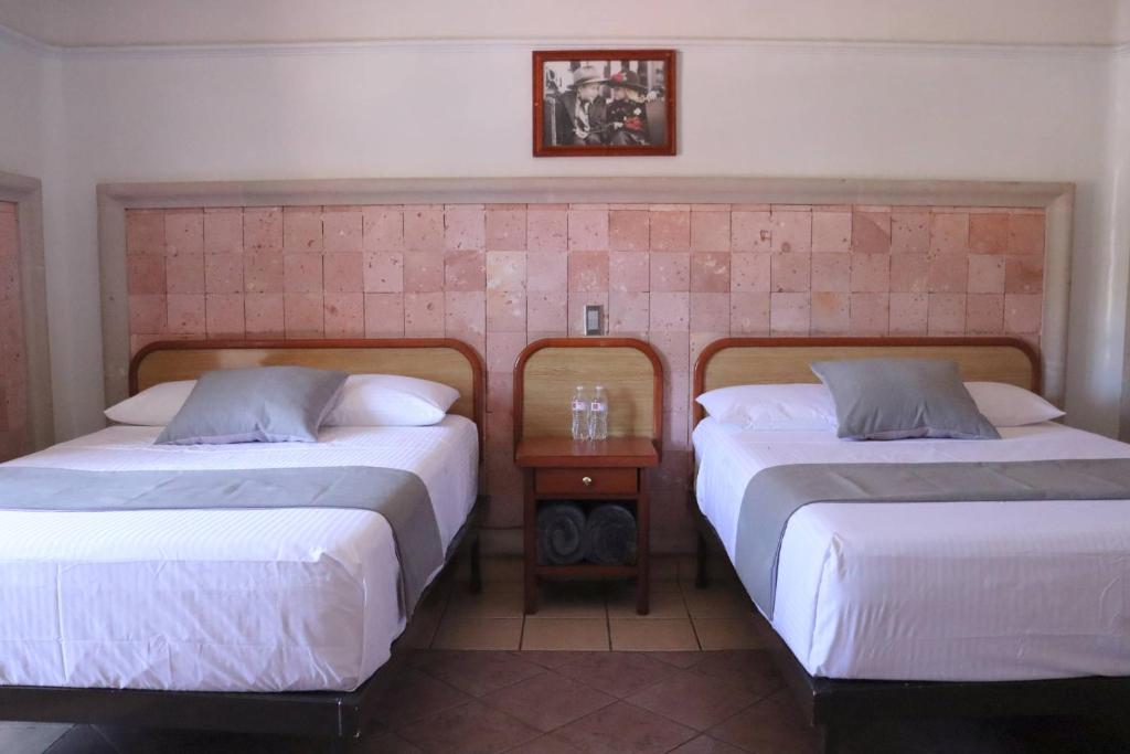 Postel nebo postele na pokoji v ubytování Hotel Riviera