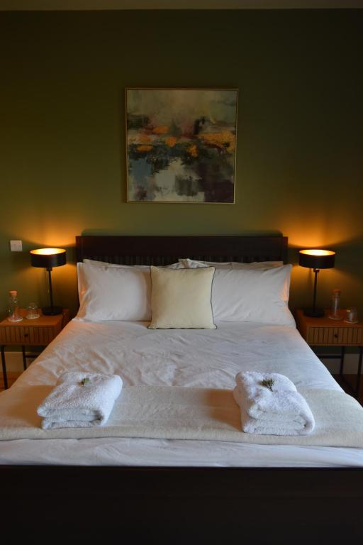 a bedroom with a bed with two towels on it at Cedarblue in Ballyvoyle Cross Roads