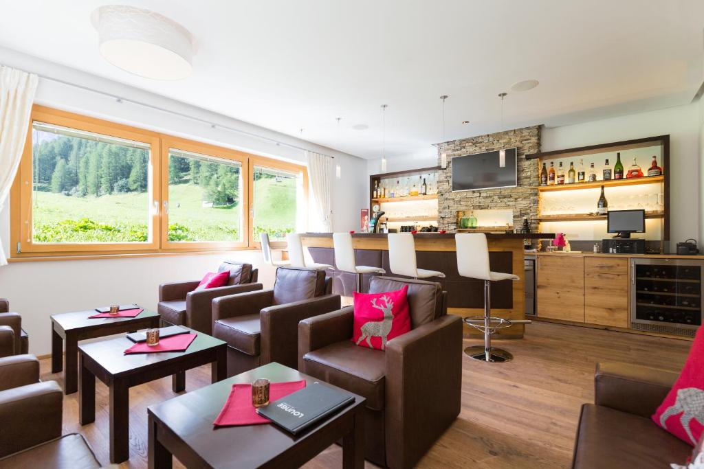 a large living room with chairs and a table at Chasa Castello relax & spa in Samnaun