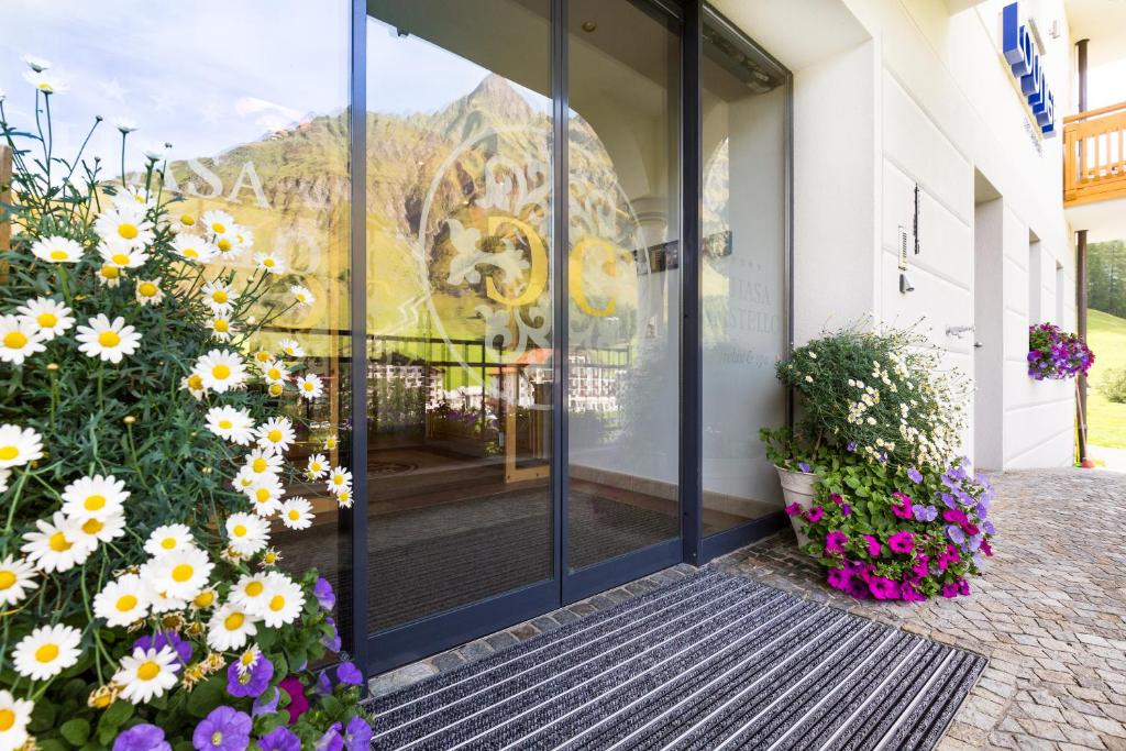 a door to a building with flowers in front of it at Chasa Castello relax & spa in Samnaun