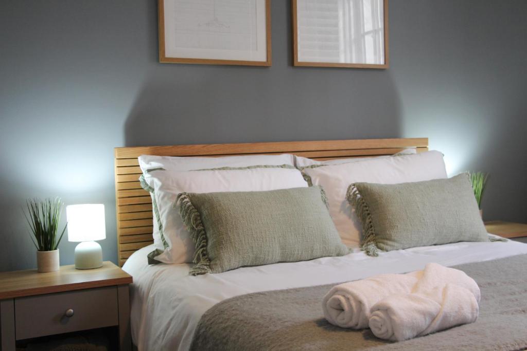 a bedroom with a bed with a towel on it at New, Luxury Apartment in Town Centre in Cheltenham