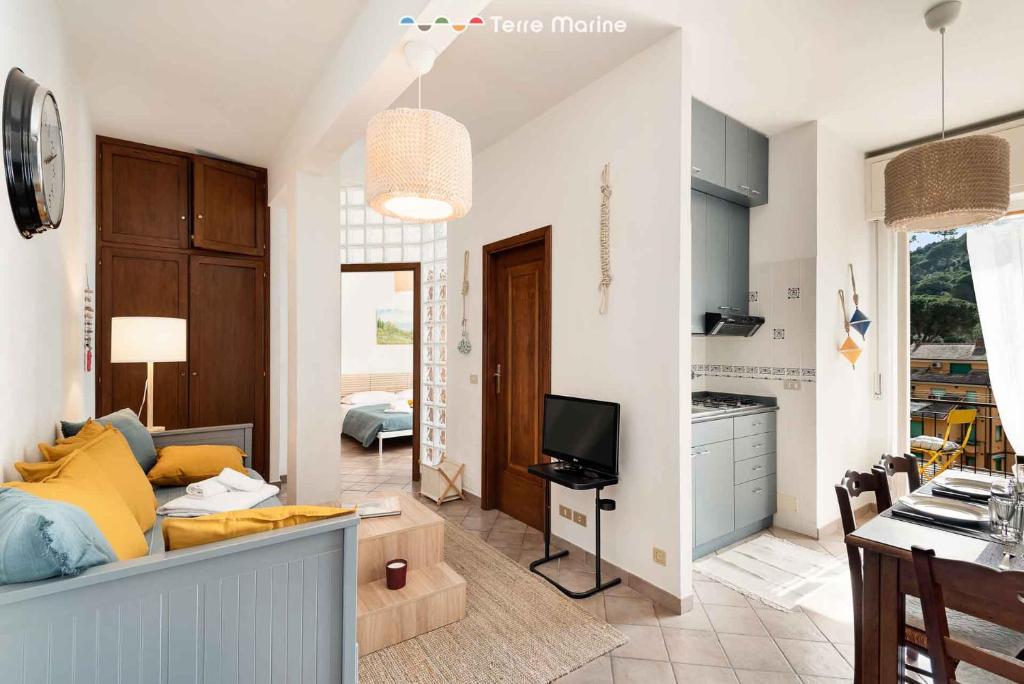 a kitchen and a living room with a couch and a tv at La Tana del Polpo in Monterosso al Mare