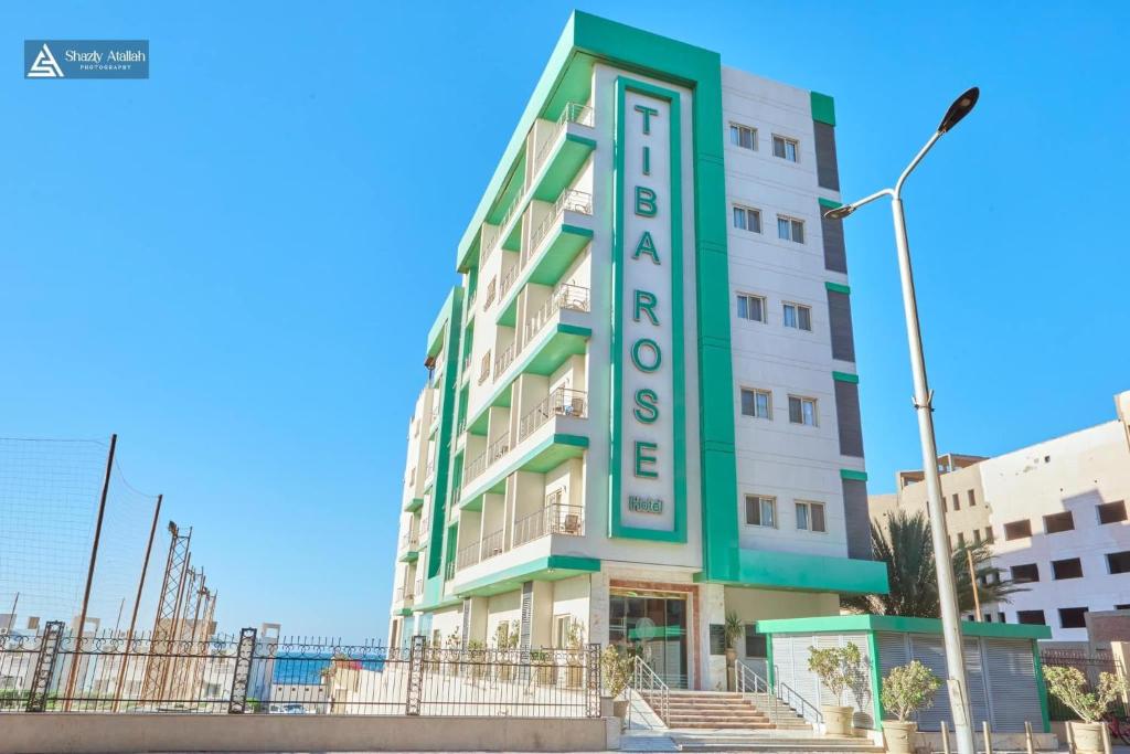 a building with a sign that says hotel at Tiba Rose hurghada in Hurghada