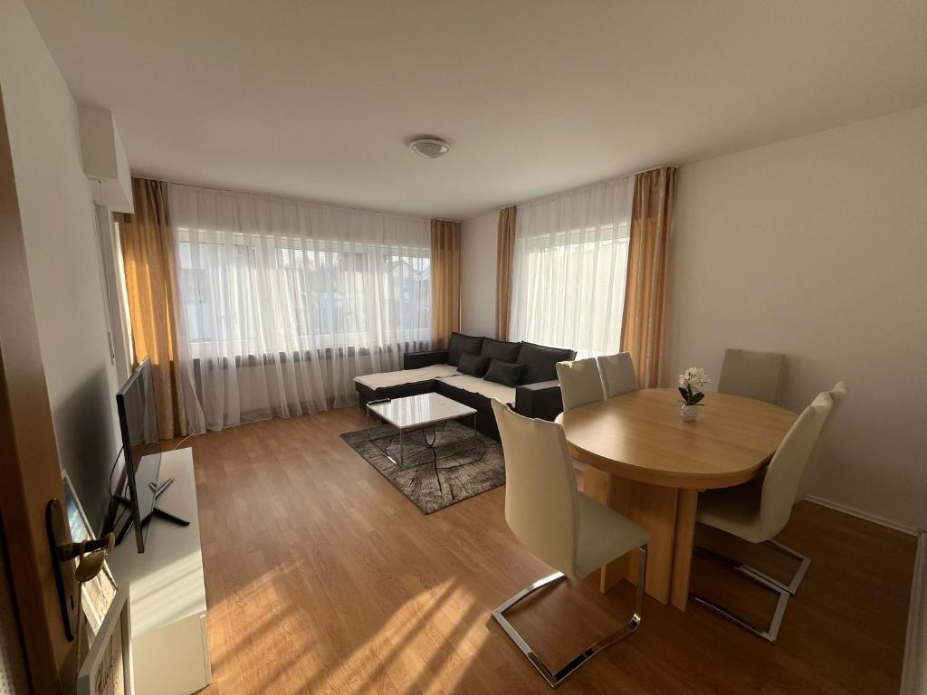 a living room with a table and a couch at Ferienwohnung in Bad Honnef in Bad Honnef am Rhein