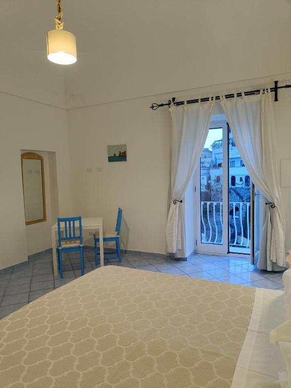 a bedroom with a large bed and a window at Regina Margherita in Positano