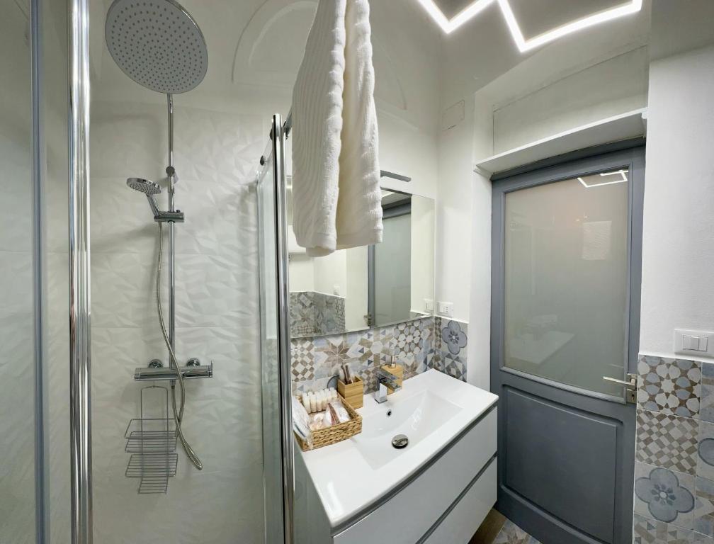 a white bathroom with a sink and a shower at Giulivi Assisi Apartments in Assisi