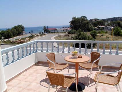 a patio with a table and chairs on a balcony at LAKIS APPARTMENTS in Faliraki