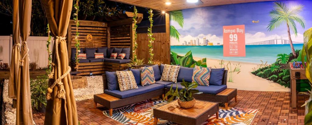 a living room with a blue couch and a mural at New Downtown Tampa Cottage for 4 in Tampa