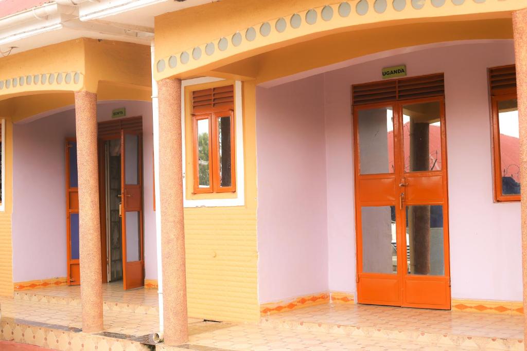 a facade of a building with orange doors at DAR Guest House in Kabarole