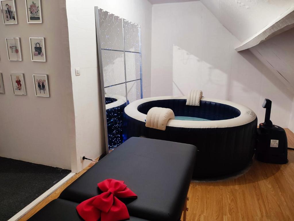 a bathroom with a large bath tub in a room at Chambre spacieuse privée avec Jaccuzi in Talmas