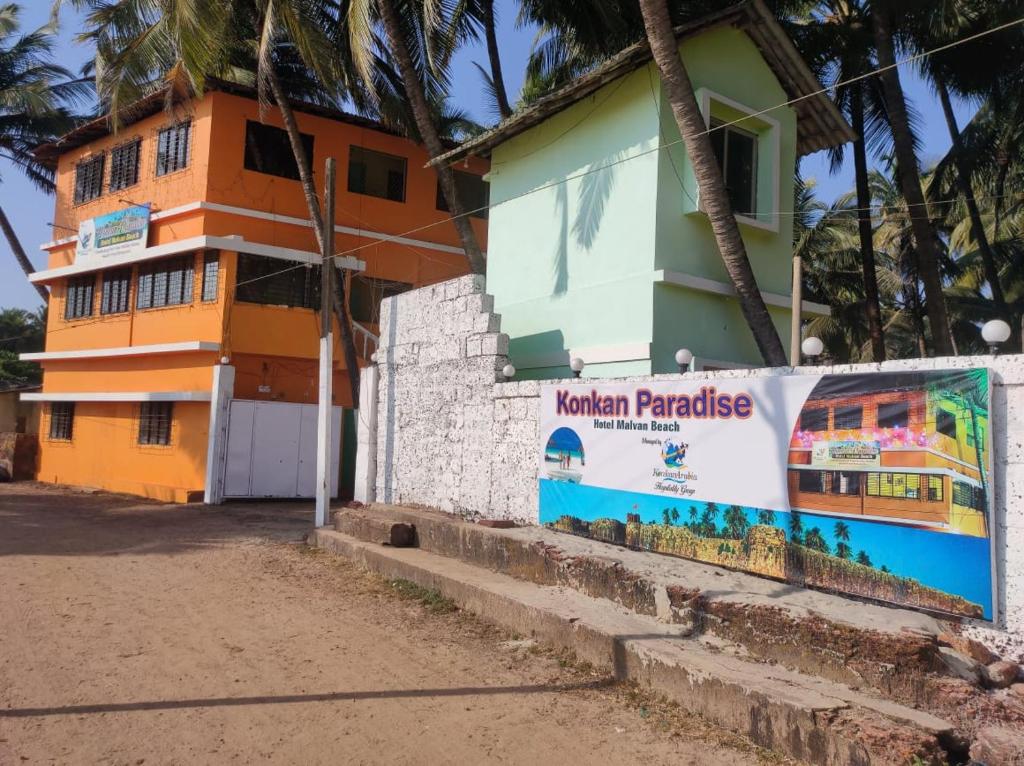 un bâtiment avec un panneau devant lui dans l'établissement KonkanParadise,Hotel Malvan Beach, à Malvan