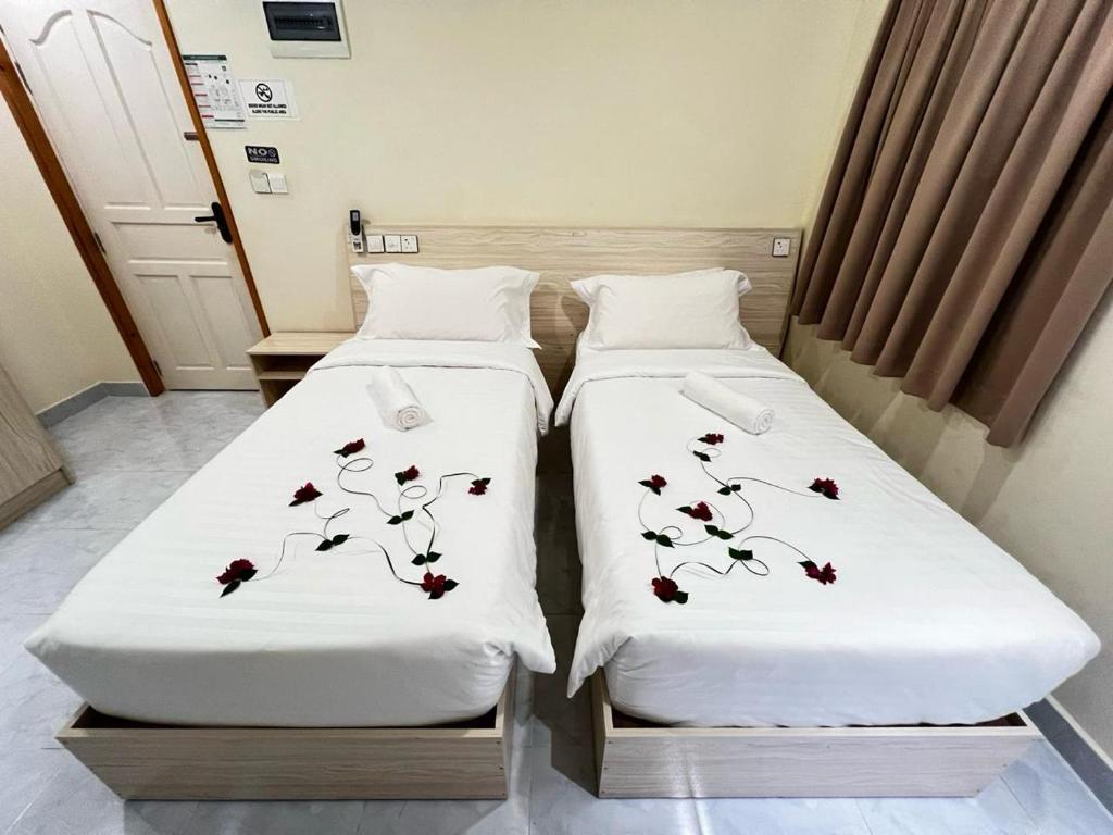 two beds sitting next to each other in a room at INFINITE LAGOON in Mandhoo
