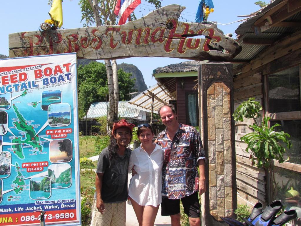 a group of people standing in front of a sign at PP Red Tuna Hut in Phi Phi Don