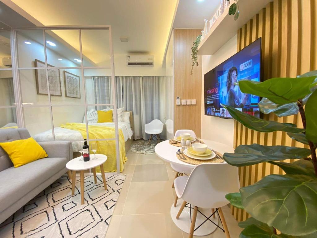 ein Wohnzimmer mit einem Sofa und einem Bett in der Unterkunft 1BR w/ Balcony near Megamall: The Admiral‘s Lounge in Manila