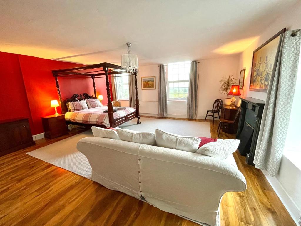 a living room with a couch and a bed at Spacious Garden Flat in Snowdonia National Park in Brynkir