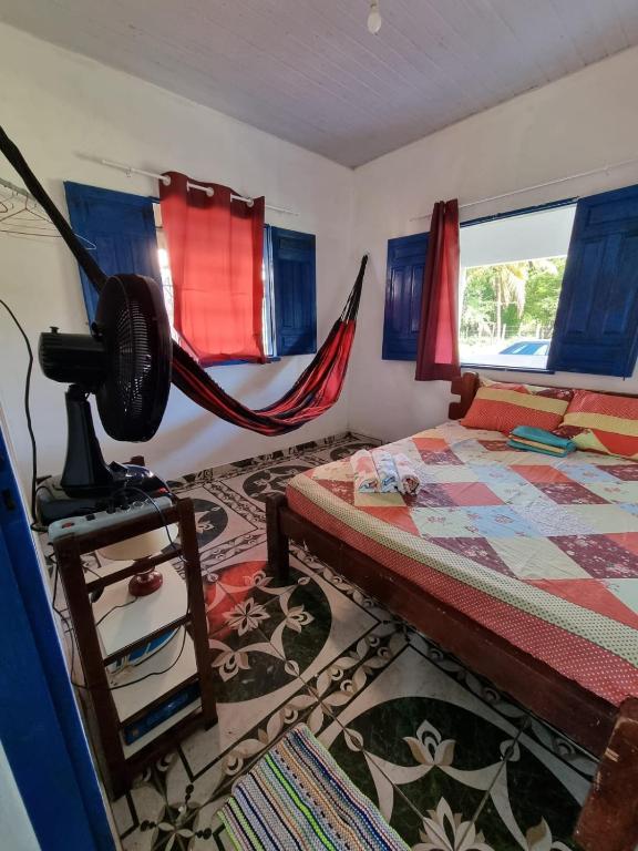 a bedroom with a bed and hammocks in it at Canto da Sereia - Casa in Soure