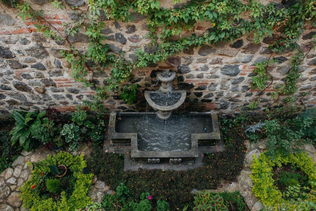 an aerial view of a stone wall with a fountain at Autumn in Antigua Boutique Hotel in Antigua Guatemala