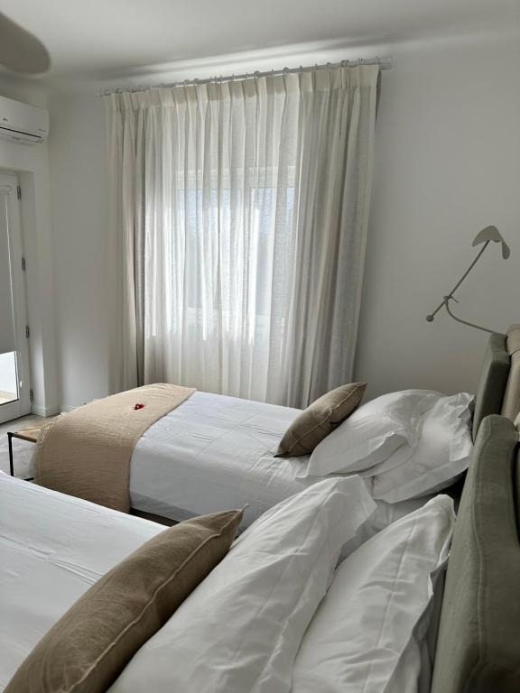 Postel nebo postele na pokoji v ubytování Casa Malìa Luxury Guest House