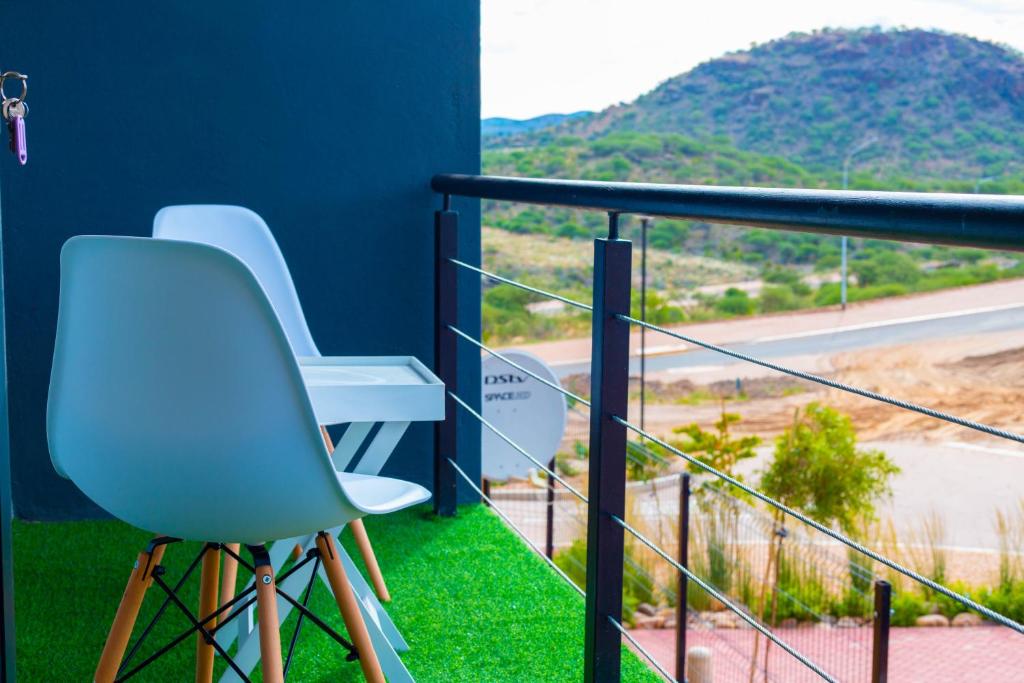 a balcony with chairs and a view of a mountain at ABGS AIR BnB 2 Bedroom Apartment in Lafrenz Township