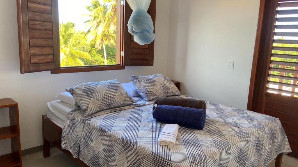 a bedroom with a bed with two towels on it at Casa da GabiLu in Itapipoca