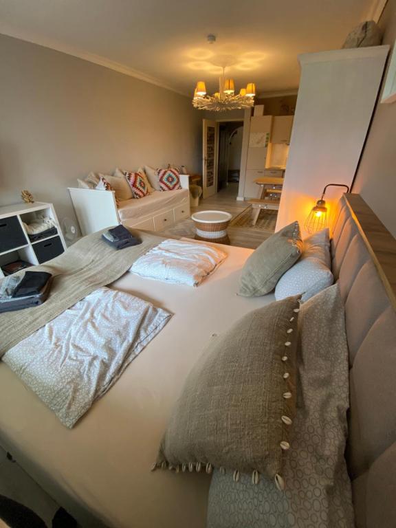 a large bed with pillows on it in a room at Ferienwohnung Darosa Gipfelglück in Seeg