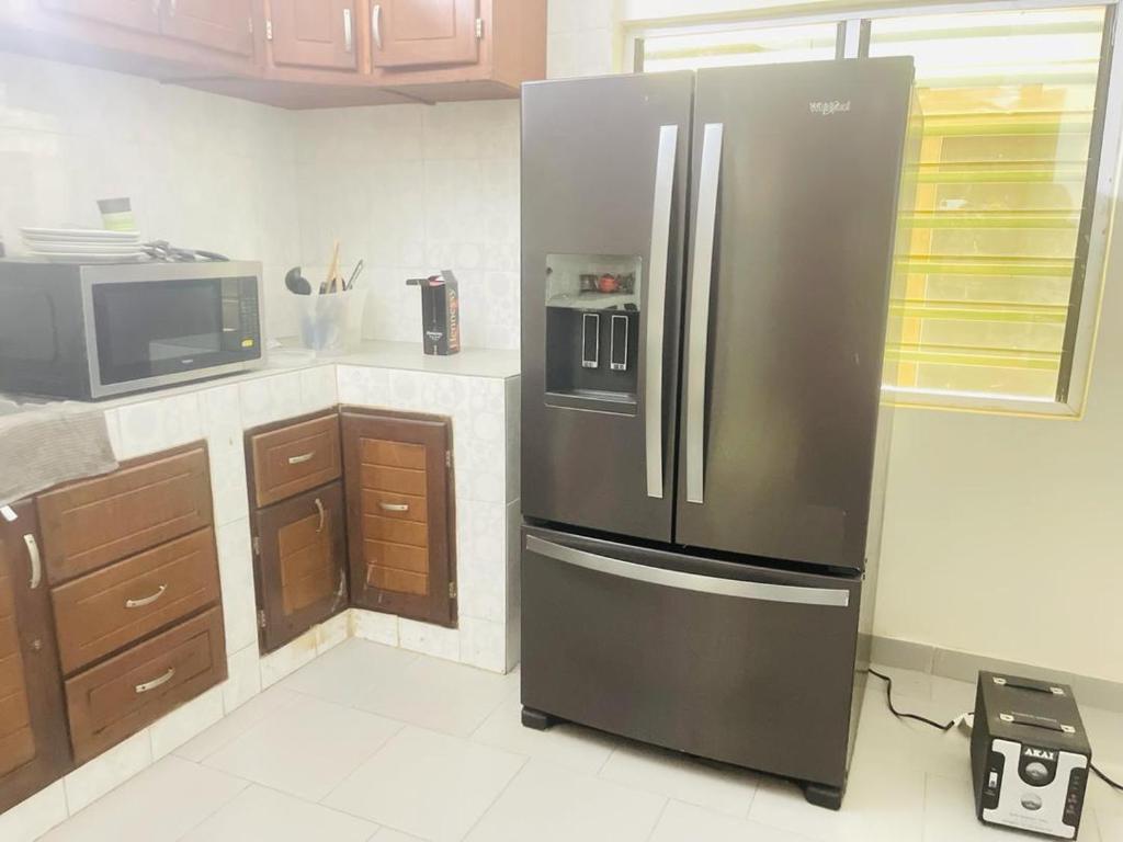 a kitchen with a large stainless steel refrigerator at Coquet appart in Abomey-Calavi