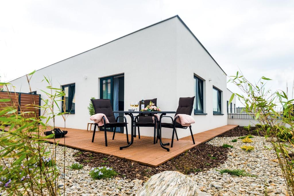 a patio with a table and chairs on a wooden deck at Residence Trafick in Prague