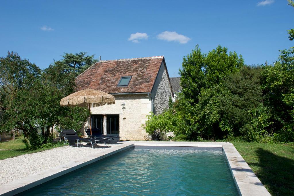a house with a swimming pool in front of a house at Maison Saint Georges in Saint-Georges-sur-Cher