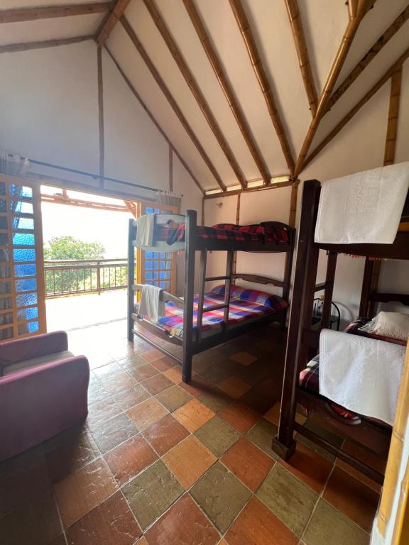 a room with bunk beds in a room with a window at Sinadan in Barbosa