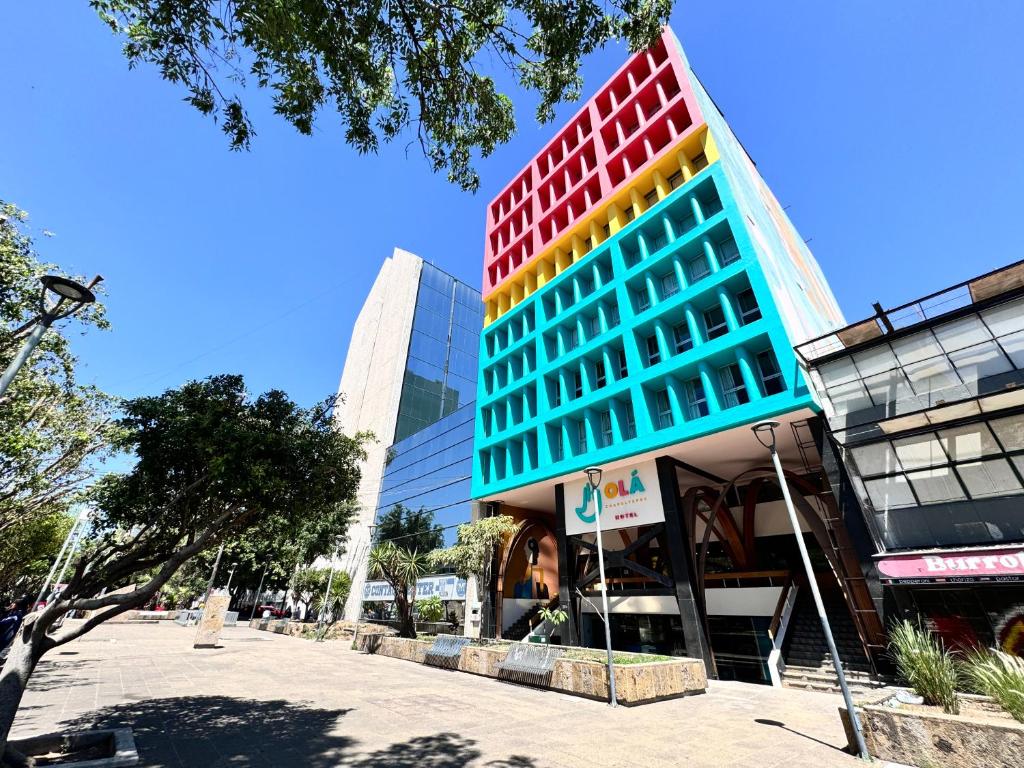 a tall building with colorful windows in a city at Hotel Olá Chapultepec in Guadalajara