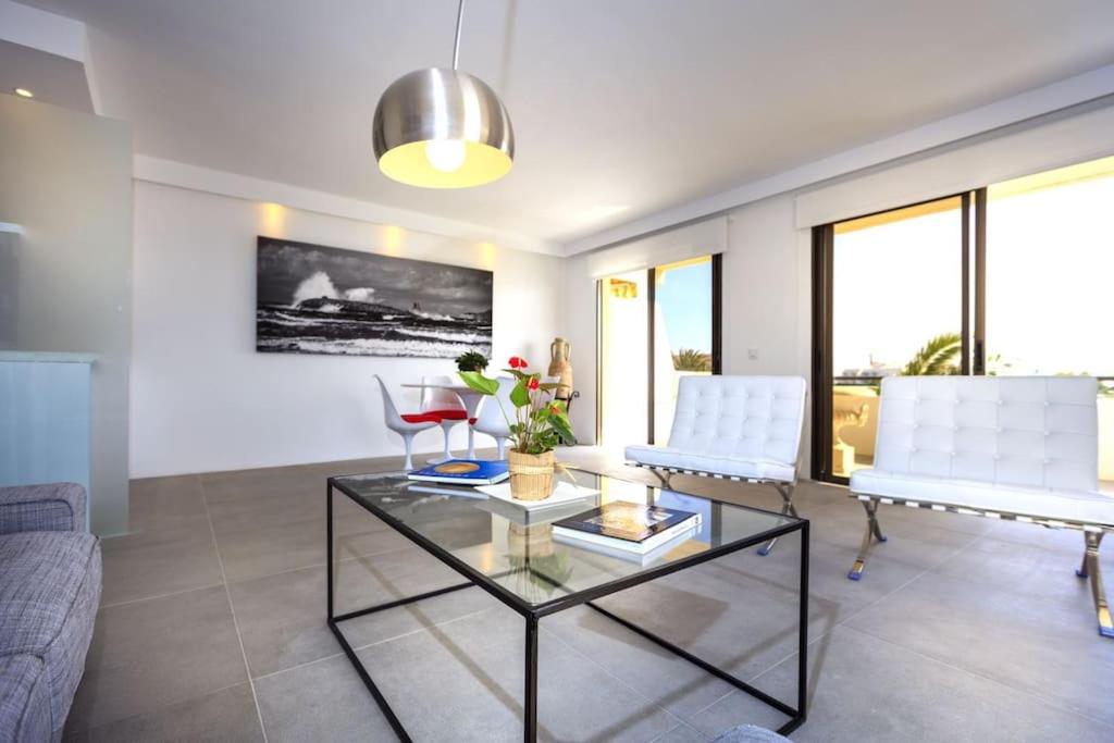 a living room with a couch and a glass table at La Savina Dream in La Savina
