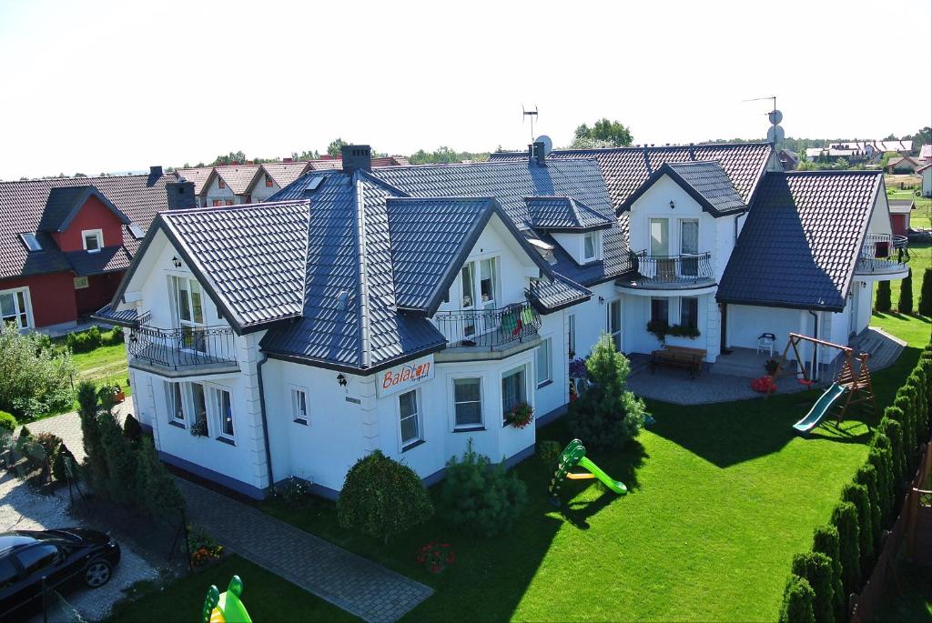 an aerial view of a large house with roofs at Balaton Rowy in Rowy