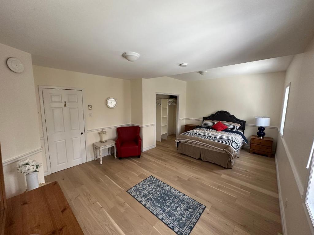a bedroom with a bed and a wooden floor at Eden Estate B&B in Reidville