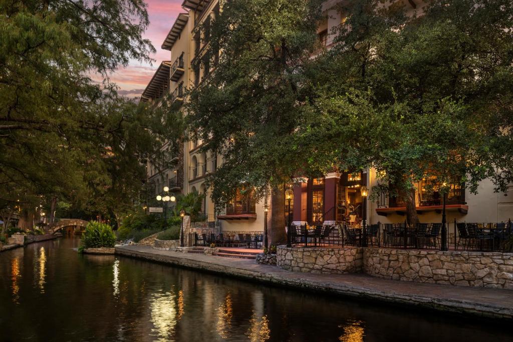 a river with buildings next to a canal at Omni La Mansion del Rio in San Antonio