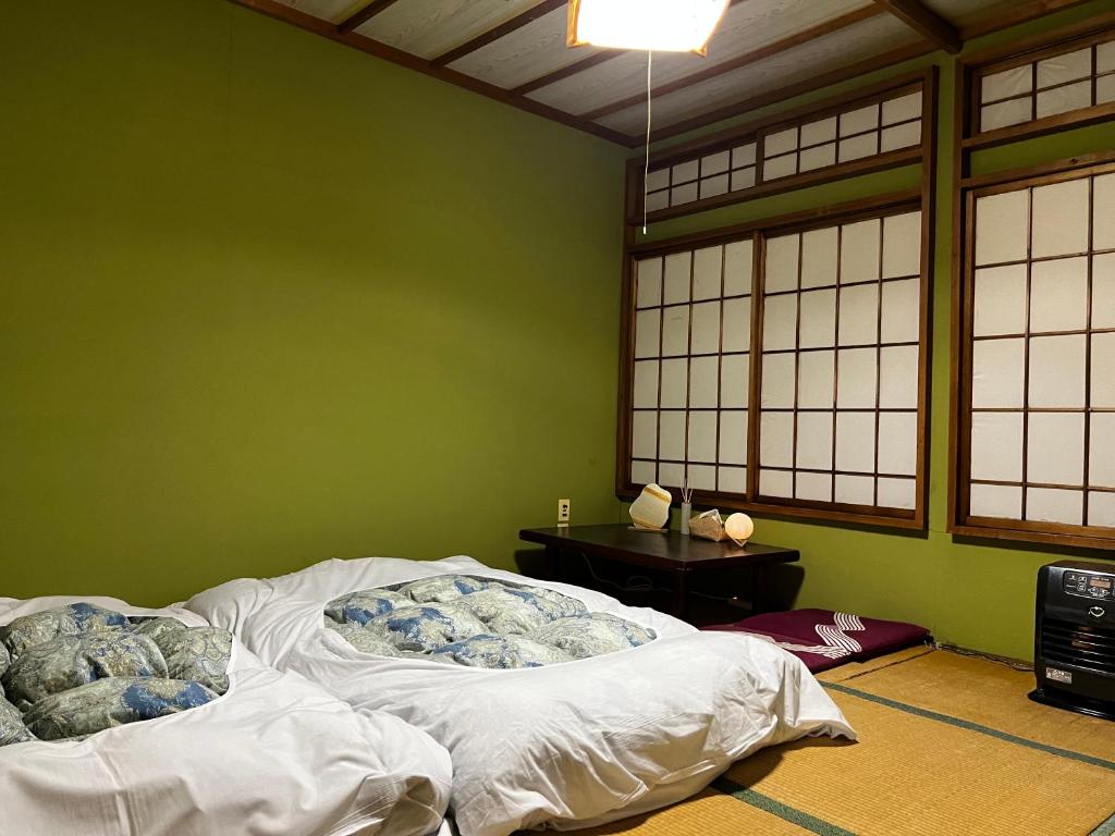 Postel nebo postele na pokoji v ubytování 苗場 中村屋