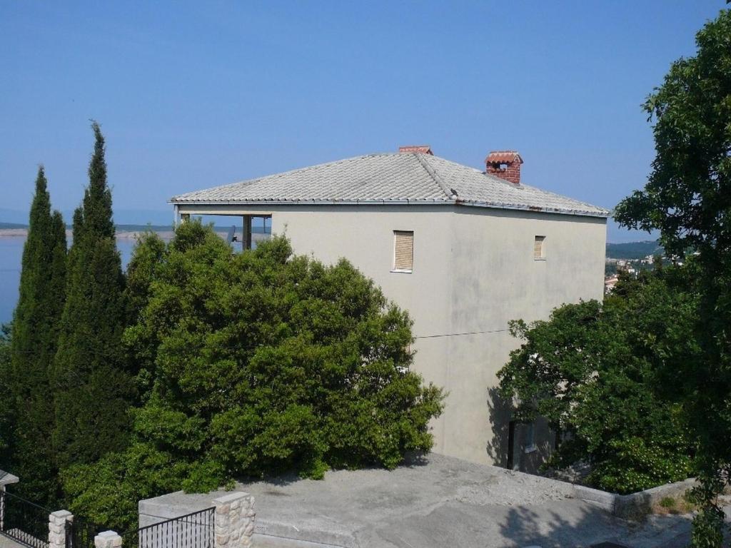 a large white house with trees in front of it at Apartments with parking space Crikvenica - 20720 in Crikvenica
