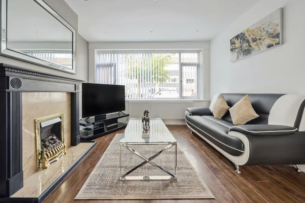 a living room with a couch and a fireplace at house in Heald Green village in Manchester