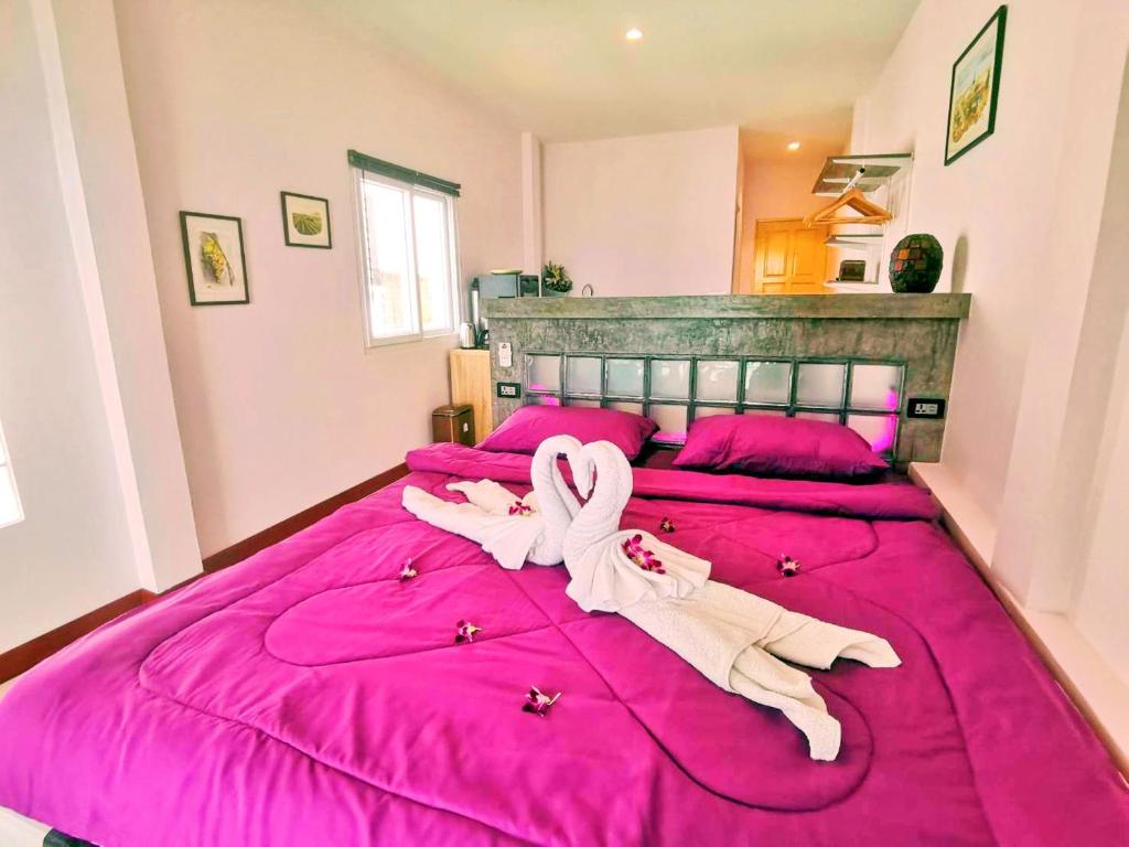 Postel nebo postele na pokoji v ubytování Mango Tree Villa